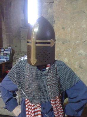 The image is entitled: ‘Image 01: The Alienated Academic. Credit: Authors’ Personal Archive.’ It shows an academic in mediaeval chainmail and head guard, posing with hands akimbo.