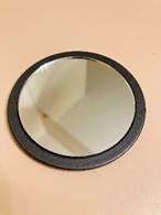 A small round mirror with a black frame

AI-generated content may be incorrect.